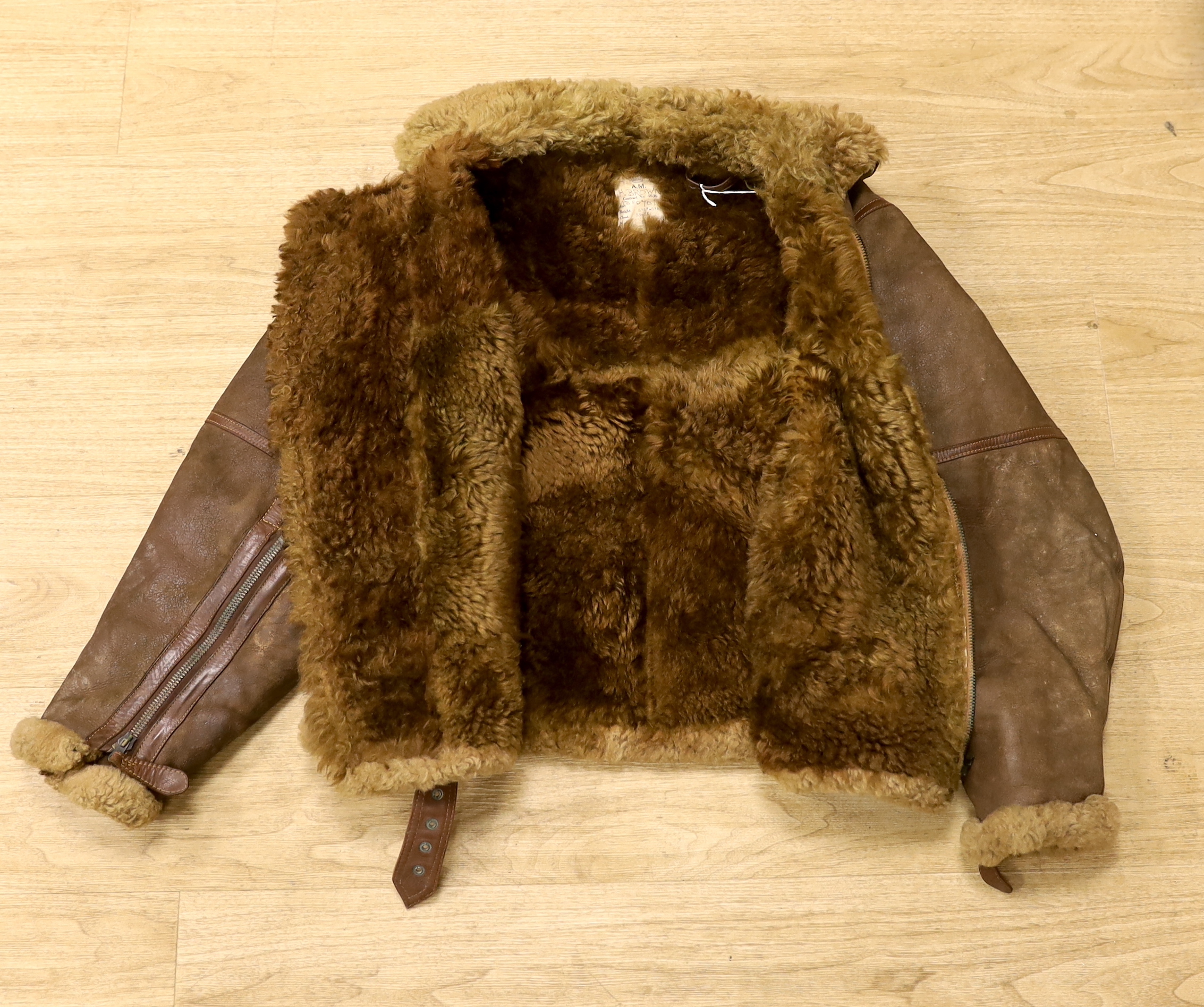 A WWII Air Ministry issue RAF sheepskin flying jacket, with original label stating; ‘AM Contract No.4636, Size: 2, Height: 5’5”-5’6”, Chest: 33-35, Waist: 30-32’, added in pen; H. Brown 130701, provenance - by family des